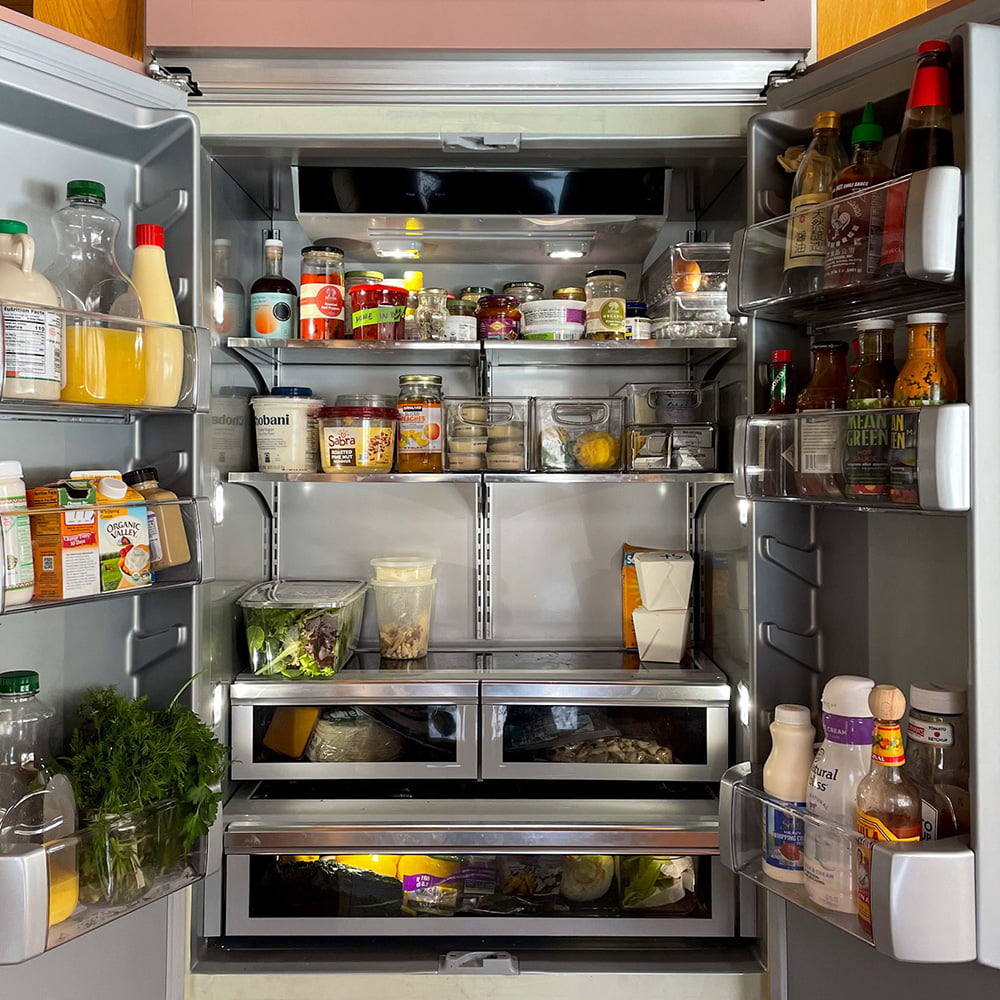 Open refrigerator filled with a variety of fresh and delicious food items.