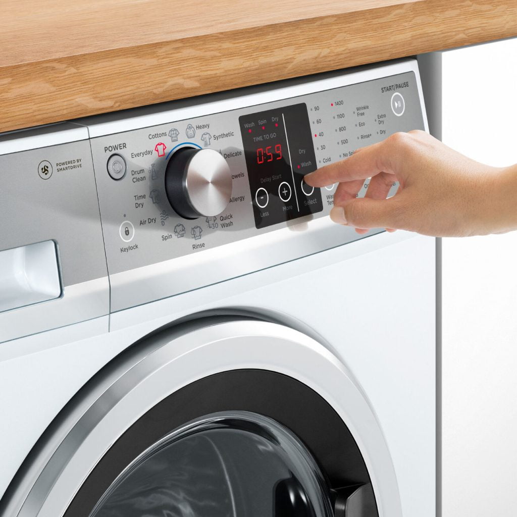 Setting a washing machine to the cotton cycle for optimal fabric care.